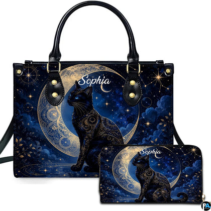 Top-handle handbag and matching zip wallet featuring an ornate celestial black cat seated before a crescent moon.