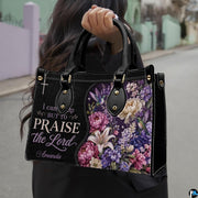 Model outdoors carrying purple floral hummingbird handbag