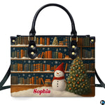 Front view of holiday handbag featuring winter library bookshelves, illuminated Christmas tree, and snowman