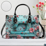 Front studio view highlighting turquoise sewing machine motif, pink roses, and textured inset disc.