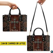 Western turquoise cross handbag paired with matching zip wallet displaying coordinated rustic motifs.