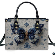 Model carrying blue porcelain butterfly handbag and matching wallet demonstrating scale
