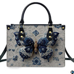 Model carrying blue porcelain butterfly handbag and matching wallet demonstrating scale