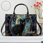 Studio presentation of celestial stained glass black cat and crescent moon artwork.