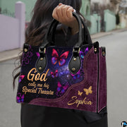 Detailed view of vibrant magenta and violet winged butterflies against stardust background on handbag.