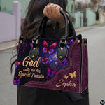 Detailed view of vibrant magenta and violet winged butterflies against stardust background on handbag.