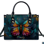 Model carrying butterfly handbag and matching wallet demonstrating scale