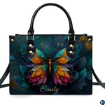 Model carrying butterfly handbag and matching wallet demonstrating scale