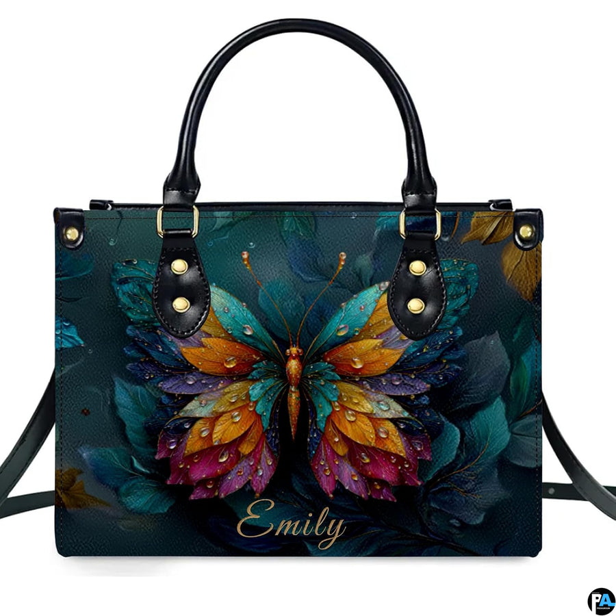 Model carrying butterfly handbag and matching wallet demonstrating scale