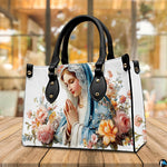 Praying Virgin Mary devotional handbag placed on tabletop beside window.