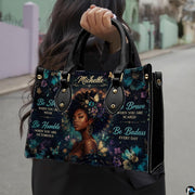 Model carrying floral afro portrait handbag with teal flowers