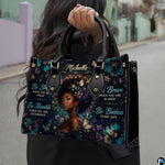 Model carrying floral afro portrait handbag with teal flowers