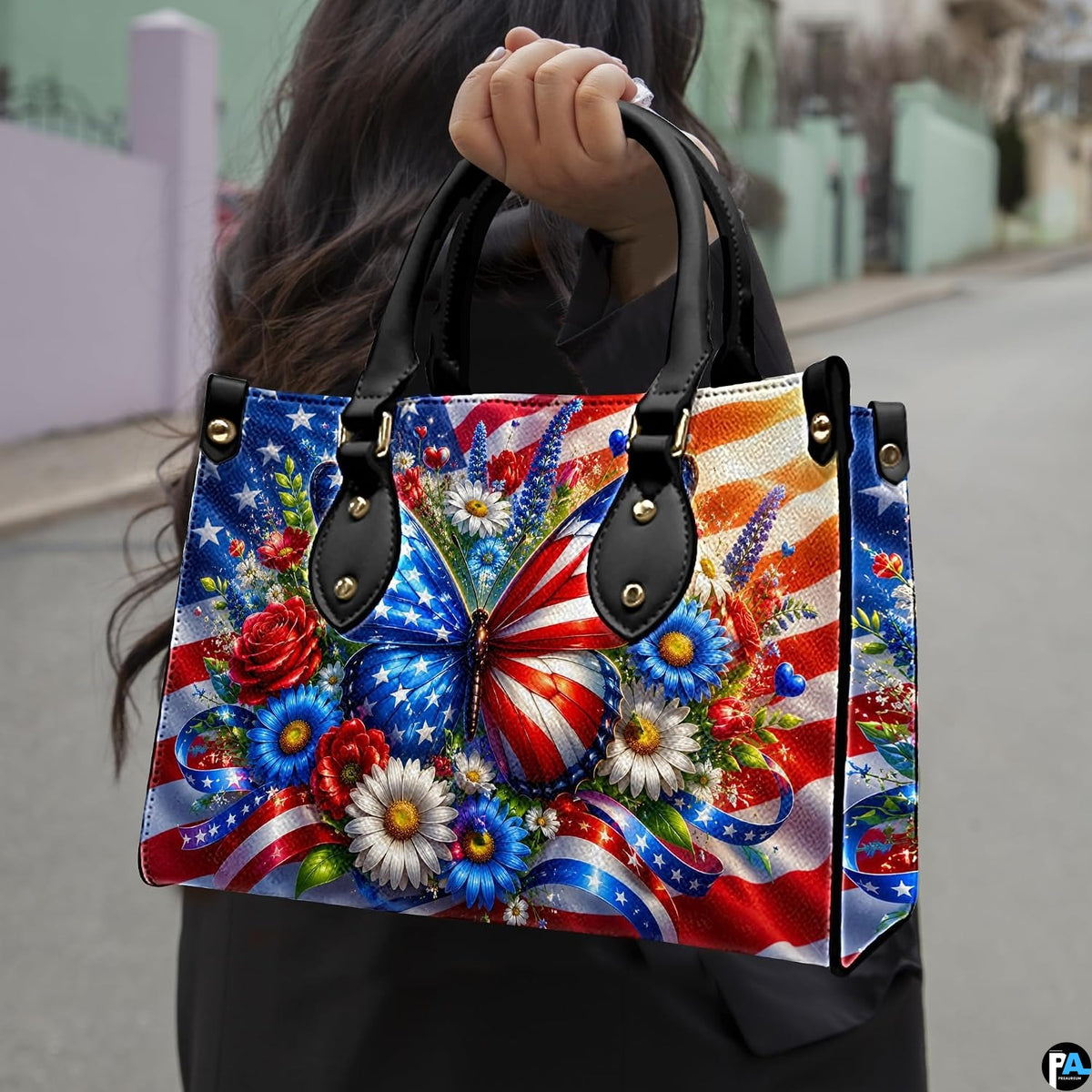 Model holding patriotic butterfly floral handbag outdoors