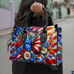 Model holding patriotic butterfly floral handbag outdoors