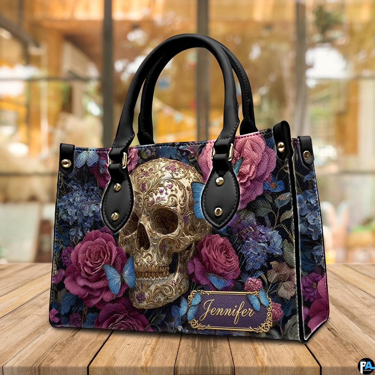 Filigree skull handbag displayed on wooden plank table before indoor window.