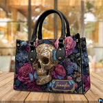Filigree skull handbag displayed on wooden plank table before indoor window.