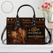 Front view of African portrait handbag with geometric bronze border