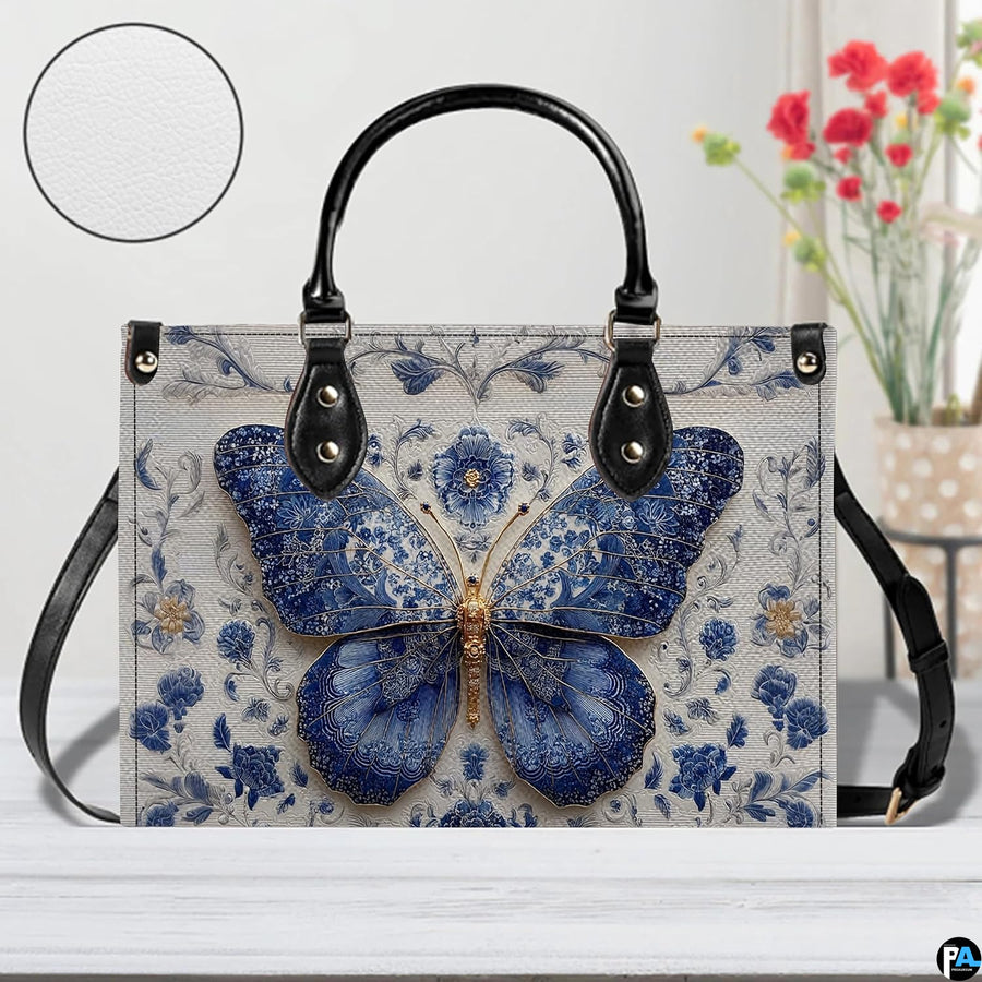 Tabletop cafe view of Delftware floral butterfly handbag standing on wooden surface