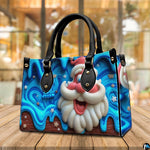 Side by side display of Santa holiday handbag and coordinating blue drip zippered wallet