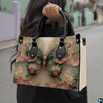 Street lifestyle view of emerald Rococo butterfly handbag held by hand on sidewalk