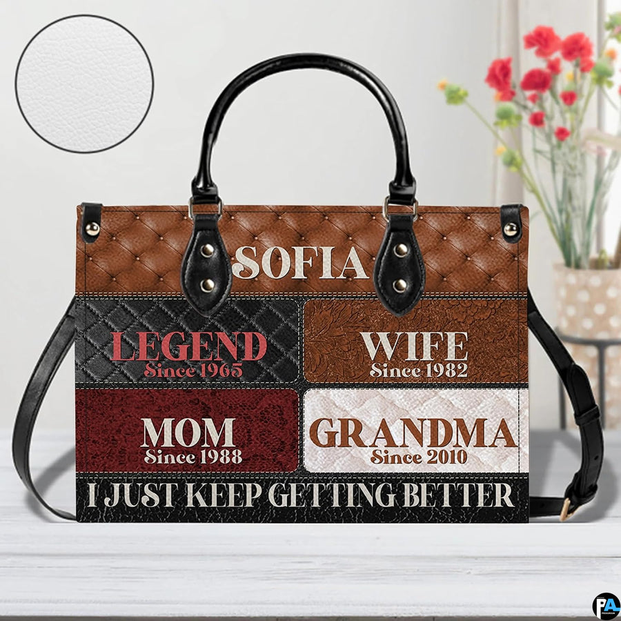 Arrangement of handbag and wallet showing matching cognac patchwork and quilted patterns.