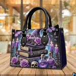 Witchcraft themed handbag resting on wooden cafe table with warm bokeh backdrop.