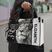 Outdoor presentation demonstrating the devotional crowned lion handbag held by a model.