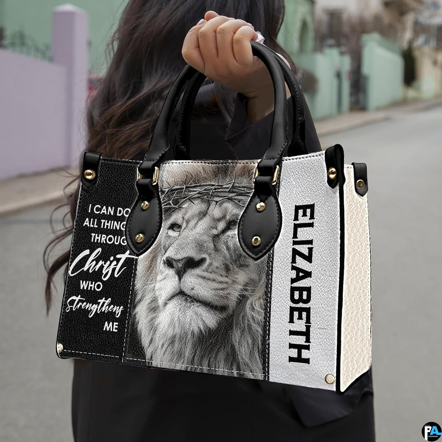 Outdoor presentation demonstrating the devotional crowned lion handbag held by a model.
