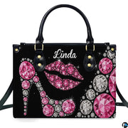 Front view of sparkling pink diamond high heel and rhinestone lips motif on a dark backdrop.