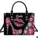 Front view of sparkling pink diamond high heel and rhinestone lips motif on a dark backdrop.