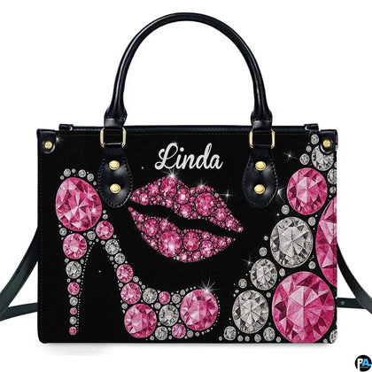Front view of sparkling pink diamond high heel and rhinestone lips motif on a dark backdrop.