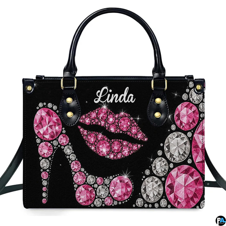Front view of sparkling pink diamond high heel and rhinestone lips motif on a dark backdrop.