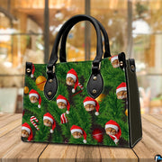 Angled tabletop perspective of holiday handbag with festive cat and evergreen pine needle print