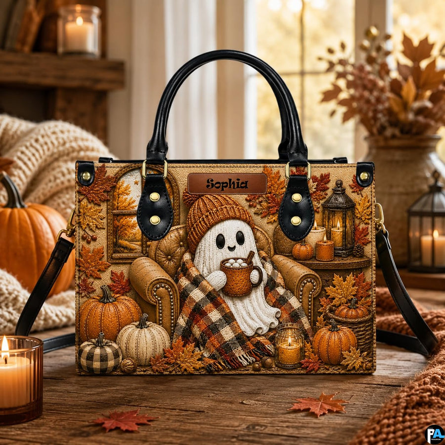 Ghost sipping cocoa satchel displayed on wooden table surrounded by autumn pumpkins and glowing candles.