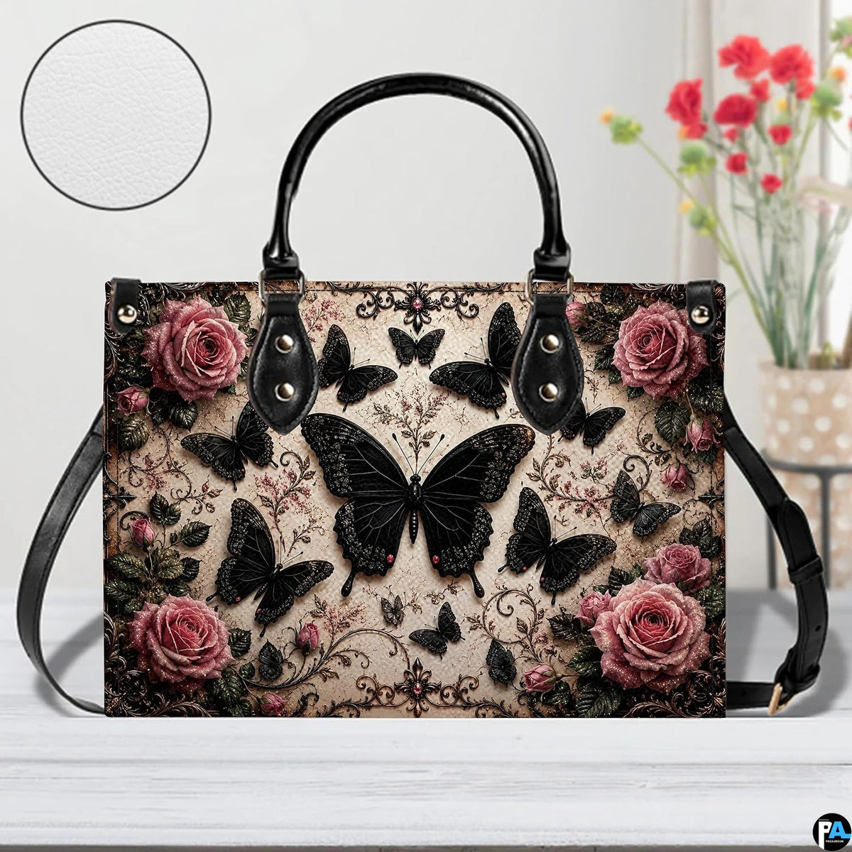 Front tabletop presentation of gothic black butterfly artwork placed beside floral vase and circular texture inset.