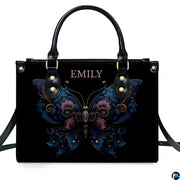 Straight-on studio portrait of black ornate floral butterfly handbag on white background
