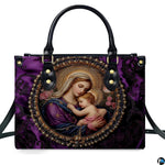 Front view of royal purple handbag displaying circular pearl cameo of Virgin Mary cradling infant Jesus.