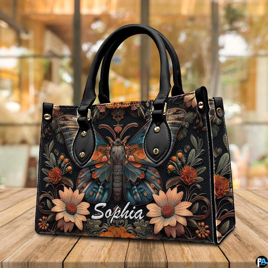 Three-quarter angle view of gothic peacock moth handbag set