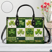 Front view of green clover handbag with mixed patterned panels and plaid accents