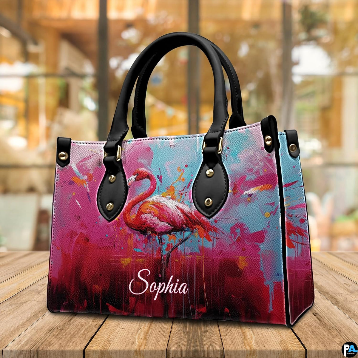 Side profile perspective of the handbag showing structured pink side panel and hardware.