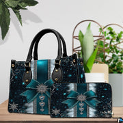 Teal snowflake bow handbag and matching wallet resting on a wooden tabletop.