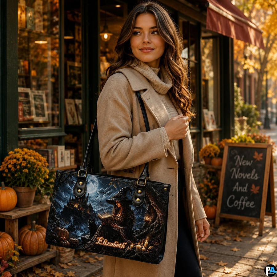Lifestyle view of woman wearing gothic witch satchel on shoulder outside autumn bookstore with pumpkin display.