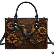 Complete set presentation of embossed hummingbird handbag and matching wallet on neutral backdrop.