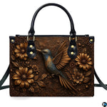 Complete set presentation of embossed hummingbird handbag and matching wallet on neutral backdrop.