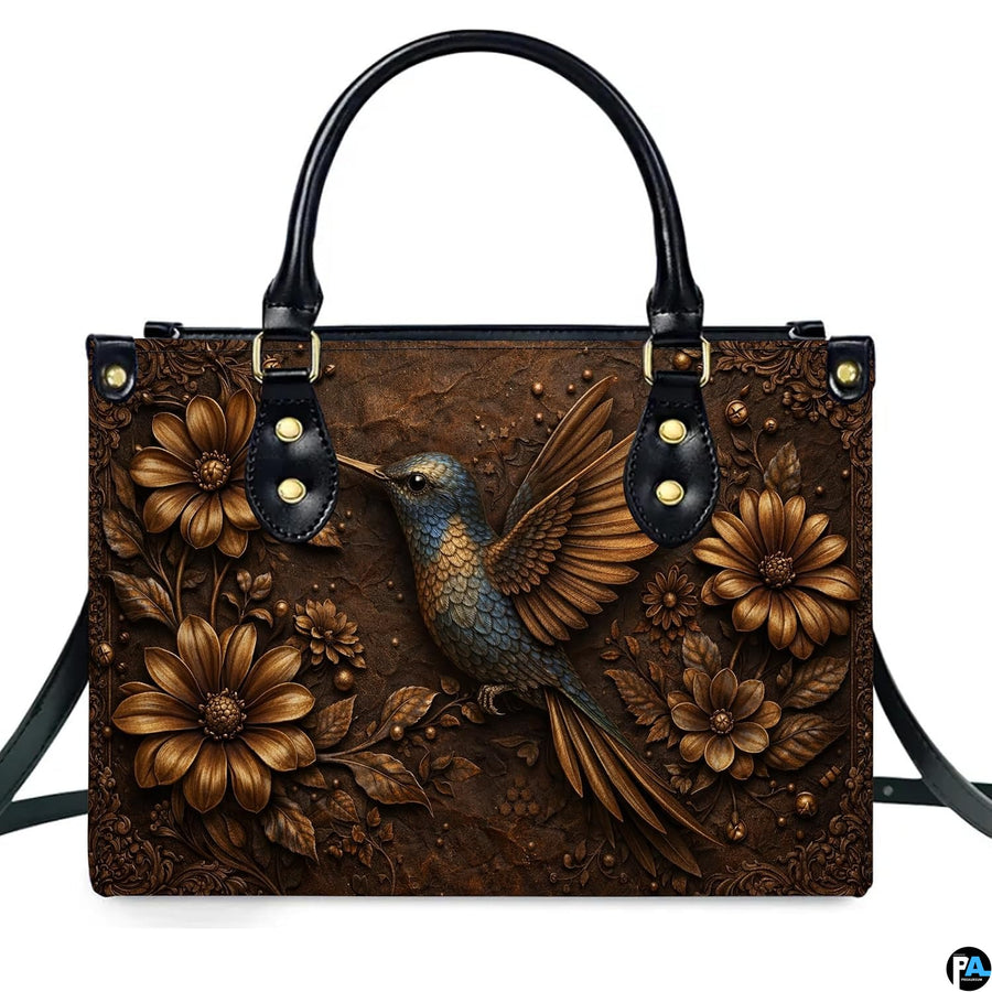 Complete set presentation of embossed hummingbird handbag and matching wallet on neutral backdrop.