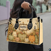 Outdoor lifestyle perspective showing smiling pumpkin artwork held by pedestrian along walkway.