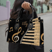 Outdoor lifestyle perspective showing golden treble clef artwork held by pedestrian along street.