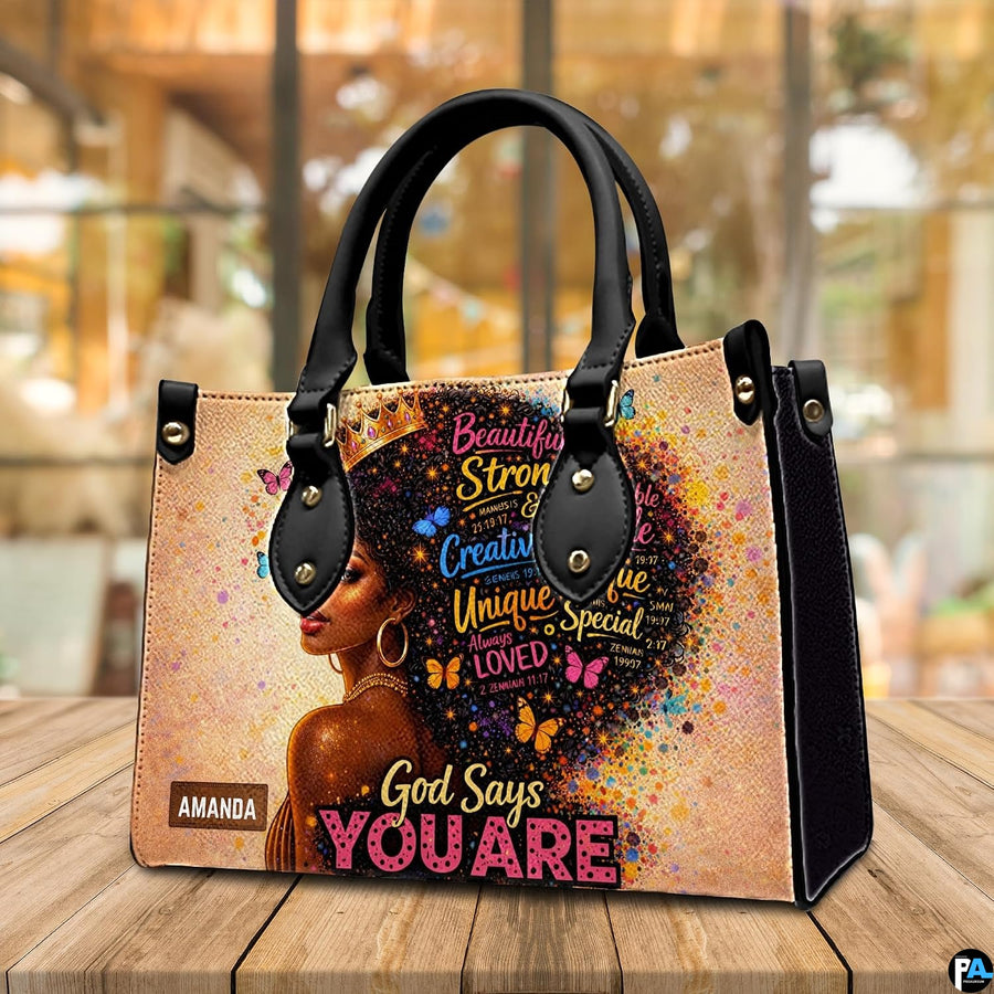 Angled view of crowned Black woman portrait handbag with butterflies