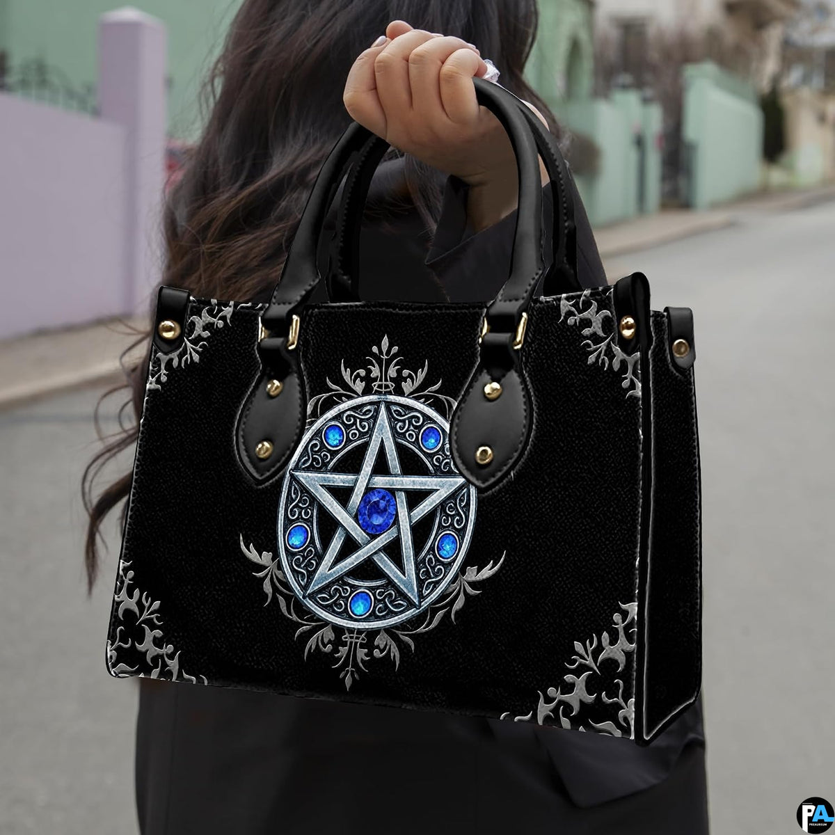 Gothic pentagram handbag held by top handle while walking outdoors along a residential street.