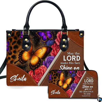 Front view of leopard print and amber butterfly handbag and matching wallet with blooming roses and diagonal trim.